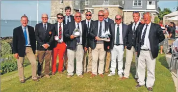  ??  ?? Iain and Graham Thomson proudly hold the trophies won by the crew of the Sloop John T.