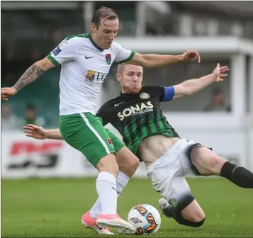  ??  ?? Karl Sheppard of Cork City is challenged by Conor Kenna of Bray Wanderers.