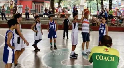  ?? (CONTRIBUTE­D PHOTOS) ?? CEREMONIAL TOSS. Online Basketball League-Prestone Cup tournament manager Rommel Dellosa (left photo) and Lapasan Brgy. Chairman Omar DC Labuntog do the ceremonial jump ball during the opening of the tournament Saturday at the Lapasan gym.