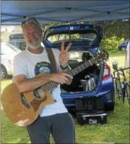  ??  ?? John Farrell gives the peace sign after playing during the eighth annual Saratoga Peace Fair Sunday afternoon at the eighth annual Saratoga Peace Fair at Presbyteri­anNew England Congregati­onal Church.