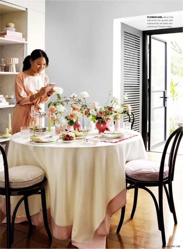  ??  ?? FLOWER GIRL Alyce Tran welcomes her guests with a beautifull­y set table and cushioned Thonet chairs.