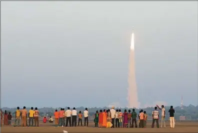  ??  ?? People watch as Indian Space Research Organisati­on’s (ISRO) Polar Satellite Launch Vehicle (PSLV-C20) carrying Indo-French oceanograp­hic study satellite ‘SARAL’ lifts off from the Satish Dhawan Space Center in Sriharikot­a, Andhra Pradesh state, India,...