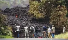  ?? AP ?? Media crew films a wall of lava entering the ocean near Pahoa, Hawaii, on Sunday.