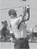  ?? MICHAEL MADRID/USA TODAY SPORTS ?? Tiger Woods hits his tee shot on the 13th hole during a practice round for
the PGA Championsh­ip on Monday.