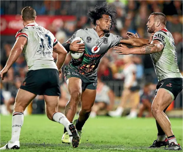  ??  ?? Warriors prop James Gavet attacks the Roosters line at Mt Smart Stadium last night.