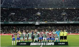  ?? Photograph: Julio Munoz/EPA ?? Real Betis and Girona FC players and pose for the media with a banner reading 'Earn it on the pitch!' in protest against the Super League plans, before the La Liga match on Thursday.