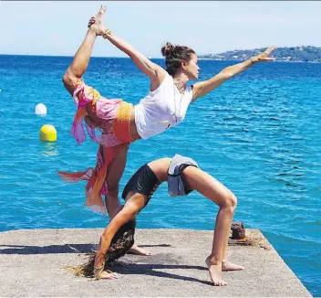  ?? THE ASSOCIATED PRESS/FILES ?? Brooke Burke-Charvet works out with her daughter, Rain, in Malibu, Calif.