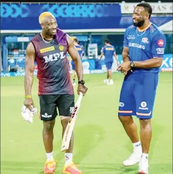  ??  ?? IN HAPPIER TIMES: KKR’s Andre Russell shares a joke with Mumbai”s Kieron Pollard during the tournament.