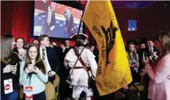  ?? — AP ?? NATIONAL HARBOR: Golden Isles Tea Party activist William Temple from Brunswick, Ga, dressed as Button Gwinnett turns with his flag and leaves in protest as former Florida Gov Jeb Bush arrives on stage with Sean Hannity of Fox News during the...
