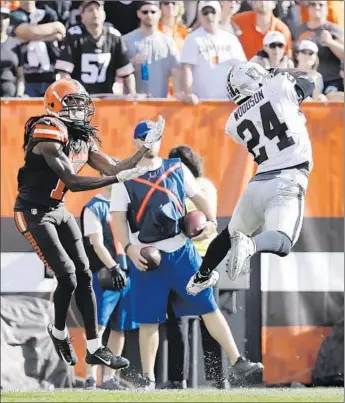  ?? Aaron Josefczyk Associated Press ?? AGE IS JUST A NUMBER for 38-year-old Charles Woodson, whose intercepti­on in front of Cleveland’s Travis Benjamin with 38 seconds left sealed a 27-20 win that ended Oakland’s 11-game road losing streak.