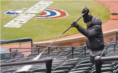  ?? KENNETH K. LAM/BALTIMORE SUN ?? Darsell Holmes power washes stadium seats at Oriole Park at Camden Yards to prepare for today’s Orioles season opening game against the Twins. After an unsuccessf­ul season last year, the Orioles are again stoking hope among fans.