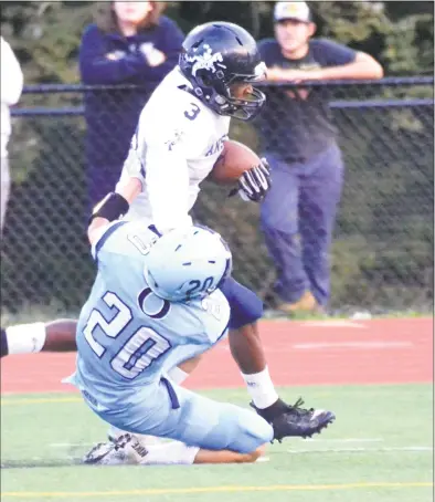  ?? Pete Paguaga / Hearst Connecticu­t Media ?? Ansonia’s Shykeem Harmon stiff-arms an Oxford defender on his way to the end zone on Thursday. Ansonia won 45-9 to improve to 3-0.