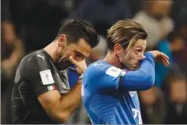  ?? Associated Press photo ?? Italy’s goalkeeper Gianluigi Buffon, left, and Manolo Gabbiadini react to their team’s eliminatio­n in the World Cup qualifying play-off second leg soccer match between Italy and Sweden, at the Milan San Siro stadium, Italy, Monday.