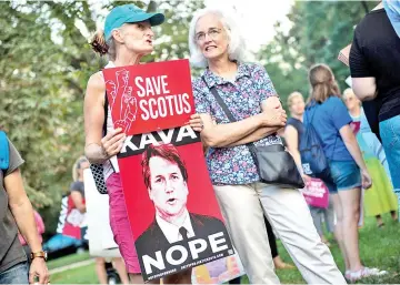  ??  ?? Protesters hold up signs during a rally near Capitol Hill against the confirmati­on hearing for Kavanaugh to be an Associate Justice on the US Supreme Court in Washington, DC. — AFP photo