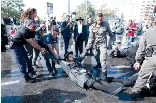  ?? (Marc Israel Sellem/The Jerusalem Post) ?? POLICE BREAK up an ultra-Orthodox protest in the capital in September.