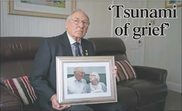  ?? (AP/Jon Super) ?? Gordon Bonner holds one of his favorite photograph­s of him with his late wife Muriel, who in April died of covid-19, at his home in Leeds, England. Bonner, 86, is just one of many hundreds of thousands of Britons toiling with grief because of the pandemic.