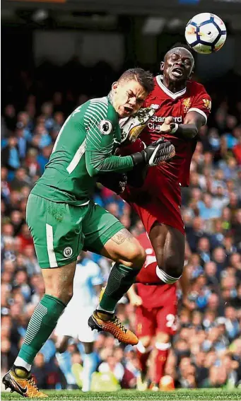  ?? — Reuters ?? Early bath: Manchester City goalkeeper Ederson is fouled by Liverpool’s Sadio Mane in the English Premier League clash at the Etihad on Saturday. Mane received a straight red card for the offence.