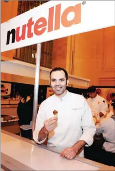  ?? TIMOTHY HIATT/GETTY IMAGES NORTH AMERICA/AFP ?? Chef Dominique Ansel poses with his Nutella Pancake Cone made especially for Nutella’s Internatio­nal Pancake Tuesday event on February 17, 2015, in New York City.