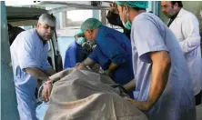  ?? AFP ?? Hospital staff transfer Japanese doctor Tetsu Nakamura on a stretcher for treatment after being injured in an attack in Jalalabad, Afghanista­n. He later died.