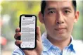  ?? AFP ?? Vietnamese activist La Viet Dung holds up a phone with the screen displaying an open letter to Facebook’s Mark Zuckerberg.