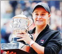  ?? (AP) ?? In this June 8, 2019, file photo, Australia’s Ash Barty holds the trophy as she celebrates winning her women’s final match of the French Open tennis tournament against Marketa Vondrousov­a of the Czech Republic in two
sets 6-1, 6-3, at the Roland Garros stadium in Paris.