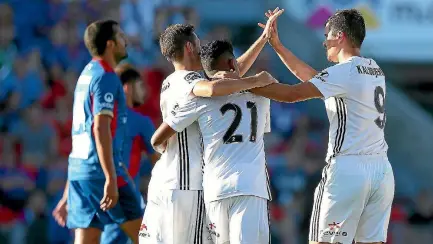  ?? GETTY IMAGES ?? Wellington Phoenix players celebrate the winning goal by Roy Krishna, centre.