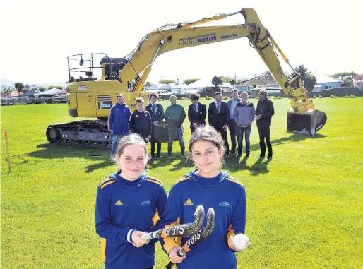  ?? PHOTO: PETER MCINTOSH ?? Turf to come . . . Sisters Sophie (13, left) and Chloe (15) Deerness, along with (from left) Otago Hockey Associatio­n general manager Andy McLean, hockey player Lachlan McAuley, King's High School (KHS) player Zeke Buschl, KHS coach Dave Ross, KHS player James Nicolson, KHS rector Nick McIvor, KHS board member Dave Booth, Otago Hockey Associatio­n board member Warren Leonard and associatio­n president John Daniel at King's High School yesterday where constructi­on of the hockey turf has begun.