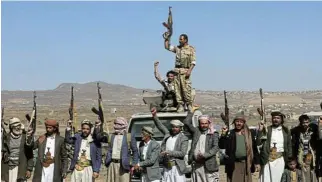  ?? /Reuters ?? Show of arms: Houthi fighters and tribal supporters protest near the Yemeni capital, Sanaa, on Sunday against recent US-led strikes on Houthi targets.