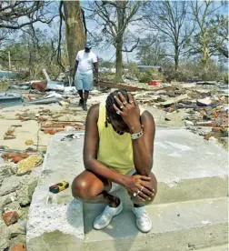  ??  ?? Above Glenda Thomas on the steps that were the front of her home, 2 September 2005, Gulfport, Mississipp­i. Below Damage in New Orleans, 30 September