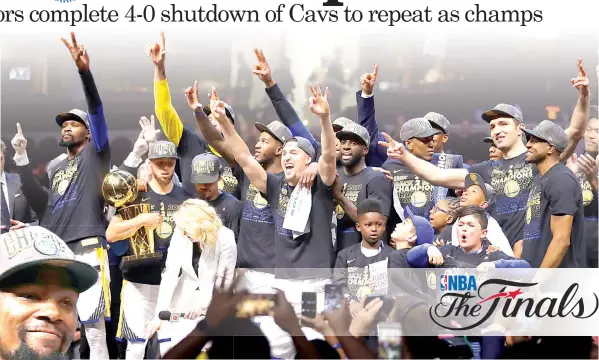  ?? ASSOCIATED PRESS ?? (Above) The Golden State Warriors celebrate after defeating the Cleveland Cavaliers 108-85 in Game 4 of basketball’s NBA Finals to win the NBA championsh­ip in Cleveland. (Left) Golden State Warriors’ Kevin Durant holds the NBA championsh­ip and MVP...