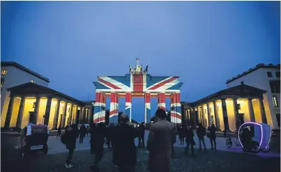  ??  ?? Berlin’s Brandenbur­g Gate is illuminate­d in tribute to the Manchester victims.