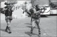  ?? AP/MAHMOUD ILLEAN ?? Israeli police take aim with tear-gas launchers Friday during a confrontat­ion with Palestinia­ns in Jerusalem’s Old City.