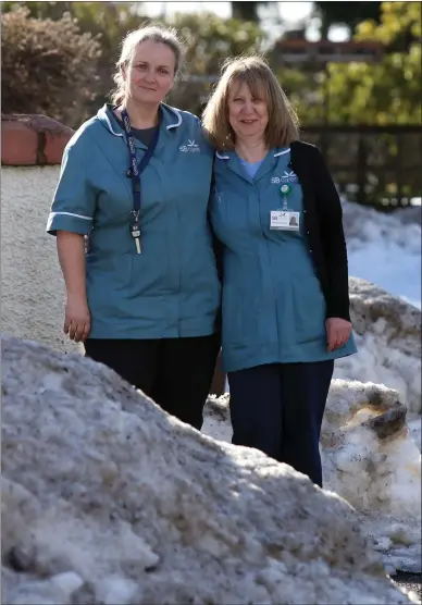 ??  ?? „ Care workers Mandy Fox, left, and Fiona Mcdairmid walked through knee-deep snow to visit their clients.