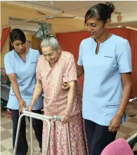  ??  ?? MARY Pillay, left, and Samantha Pillay help 93-year-old Puppli Singh with her walker at the Aryan Benevolent Home in Chatsworth.