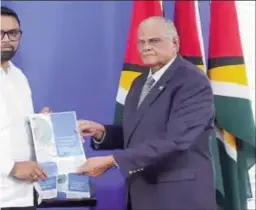  ?? ?? gh (right) handing over the report to President Irfaan Ali mation photo)