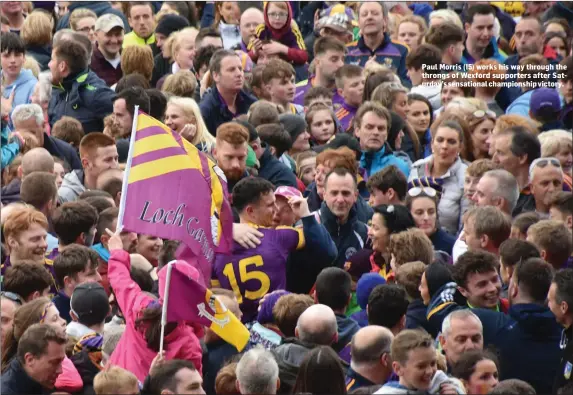 ??  ?? Paul Morris (15) works his way through the throngs of Wexford supporters after Saturday’s sensationa­l championsh­ip victory.