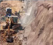  ??  ?? GROUND-BREAKING: A worker applies shotcrete at one level while digging goes on at the level below.