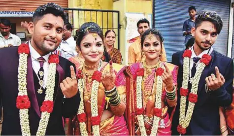  ?? PTI ?? Two newly married couples show their ink-marked fingers after casting their votes for Karnataka Assembly elections in Hubbali yesterday.