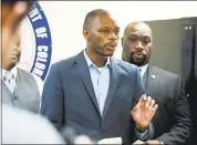  ?? THE ASSOCIATED PRESS ?? Arizona state Democratic Rep. Reginald Bolding Jr., left, successful­ly pushed for changes in the state’s driving rules that inform gun-carrying motorists how they should handle themselves if they get pulled over by police officers.