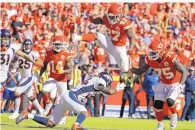  ?? CHARLIE RIEDEL/ASSOCIATED PRESS ?? Kansas City Chiefs running back Kareem Hunt (27) vaults Denver Broncos safety Wil Parks (34) on his way to a touchdown during the second half on Sunday.