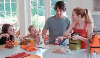  ??  ?? From left, Maude Apatow, Iris Apatow, Paul Rudd and Leslie Mann in a scene from “This is 40.”