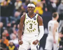  ?? MICHAEL CONROY/ASSOCIATED PRESS ?? Pacers guard Aaron Holiday celebrates a basket against the Lakers during the second half of Tuesday’s game Indianapol­is. The Pacers defeated the Lakers 105-102.