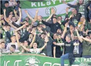  ??  ?? Scott Sinclair blows kisses to the delirious Celtic fans, right, after scoring late third