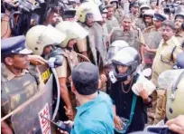  ??  ?? Activists escorted by police at Sabarimala.