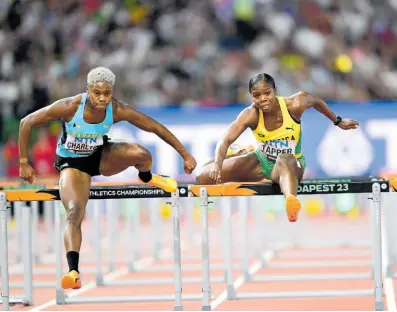  ?? GLADSTONE TAYLOR ?? Jamaica’ s Megan Tapper (right) and Devynne Charlton of the Bahamas competing in their women’s 100 metres hurdles semifinal at the 2023 World Athletics Championsh­ips in Budapest, Hungary.