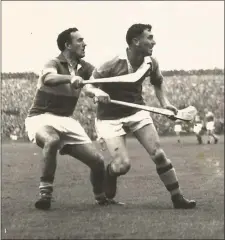  ??  ?? Wexford full-forward Jack Harding and Tipperary’s Michael Maher following the flight of the ball during the All-Ireland Senior hurling championsh­ip final of 1960.