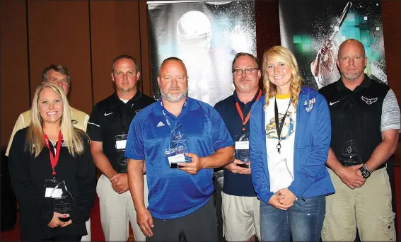  ?? NWA Democrat-Gazette/CARIN SCHOPPMEYE­R ?? Coaches Kristin Killham, Ramay Junior High (from left); Chip Durham, Bentonvill­e West; Jody Grant, Bentonvill­e; Steve Peck, Rogers; Wayne Levering, Rogers Heritage; Ashley Riggles, Decatur; and Stephen Neal, Pea Ridge, are named Kendrick Fincher...