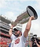  ?? AP ?? Washington Capitals captain Alex Ovechkin lifts the Stanley Cup on the field before a baseball game between the Washington Nationals and the San Francisco Giants at Nationals Park on Saturday in Washington.