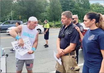  ?? Josh LaBella / Hearst Connecticu­t Media ?? Paul Veneto speaks with Portland Deputy Fire Chief Rob Puida and his wife, Kimberly Puida, Tuesday about the crew members of Flight 175 he had worked with prior to 9/11.