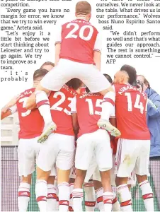  ??  ?? Arsenal players celebrates their second goal scored Alexandre Lacazette during the English Premier League football match between Wolverhamp­ton Wanderers and Arsenal at the Molineux stadium in Wolverhamp­ton, central England.